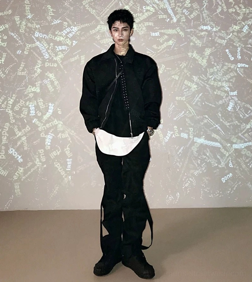 Full front view of black asymmetric zip techwear jacket with shirt collar, relaxed sleeves, and cargo pants styling