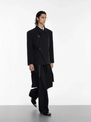 Mens black asymmetrical blazer styled with wide leg trousers in side walking view for Seoul streetwear tailoring outfit