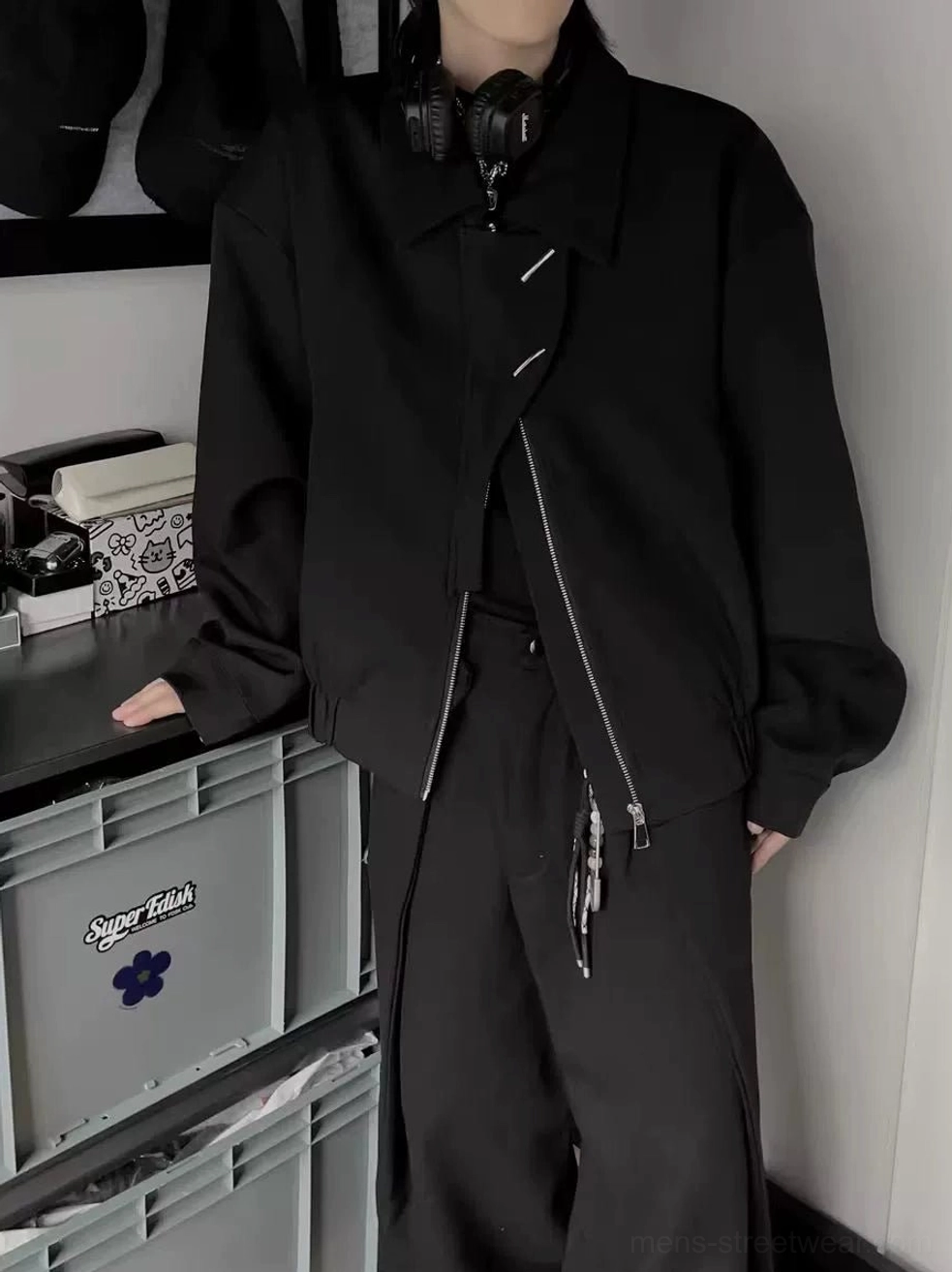Side three-quarter view of black asymmetrical zip bomber jacket with turn-down collar and oversized Korean streetwear fit