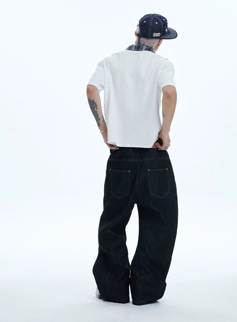 Rear view of black washed baggy wide-leg jeans with brown leather waistband patch and contrast topstitching