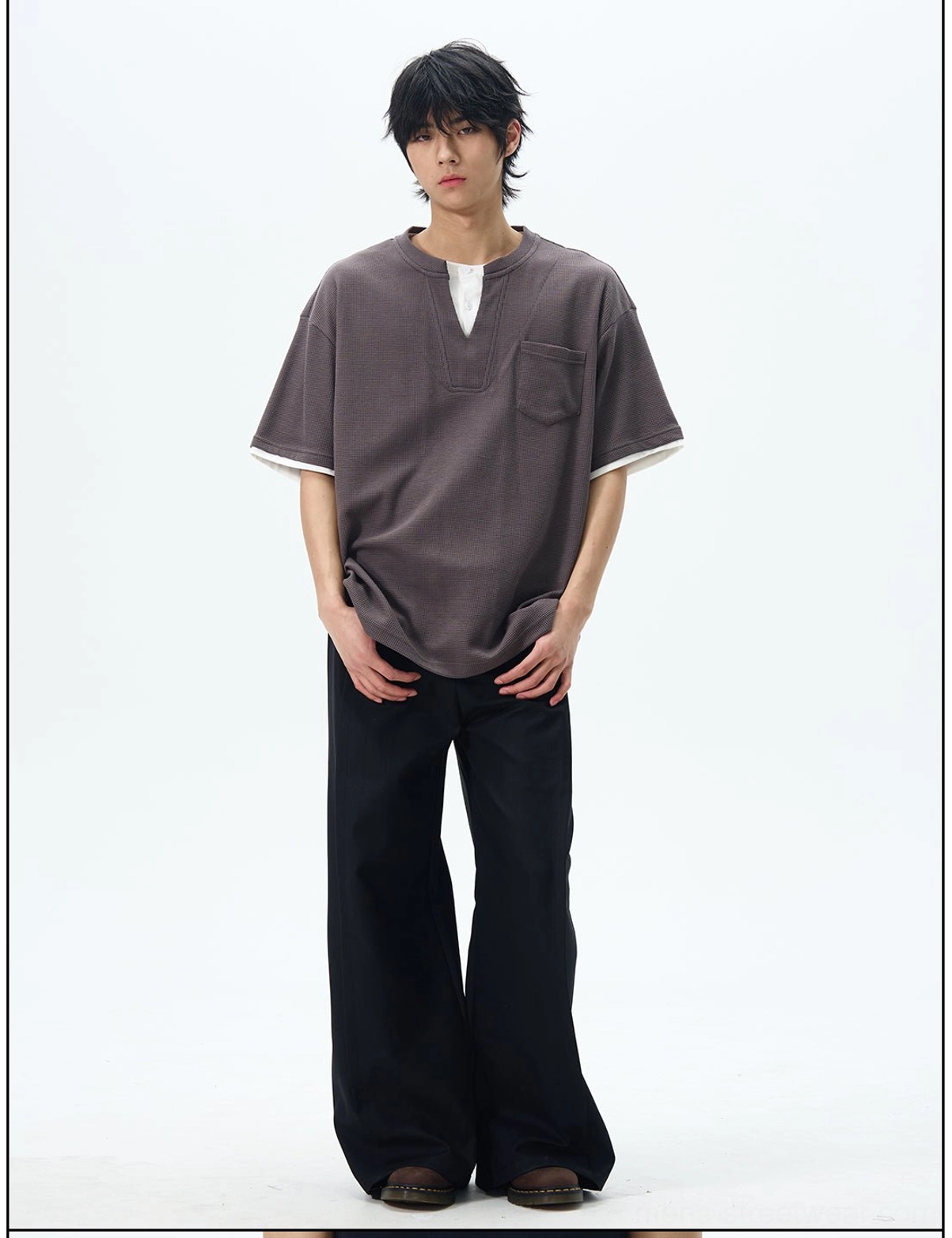 Front view of solid black baggy wide-leg pants with a neat waistband and oversized skater trousers fit