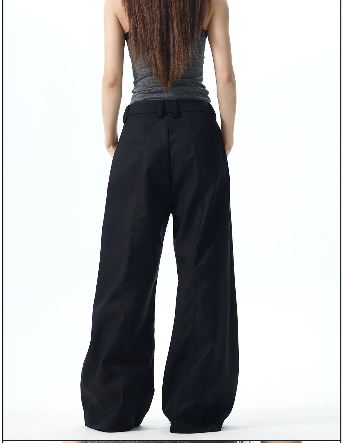 Back view of black baggy wide-leg trousers with rear pocket details, belt loops, and oversized streetwear fit