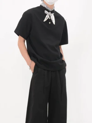 Black bandana collar polo tee in Korean streetwear style shown from a front three-quarter view with striped neckerchief and wide-leg trousers