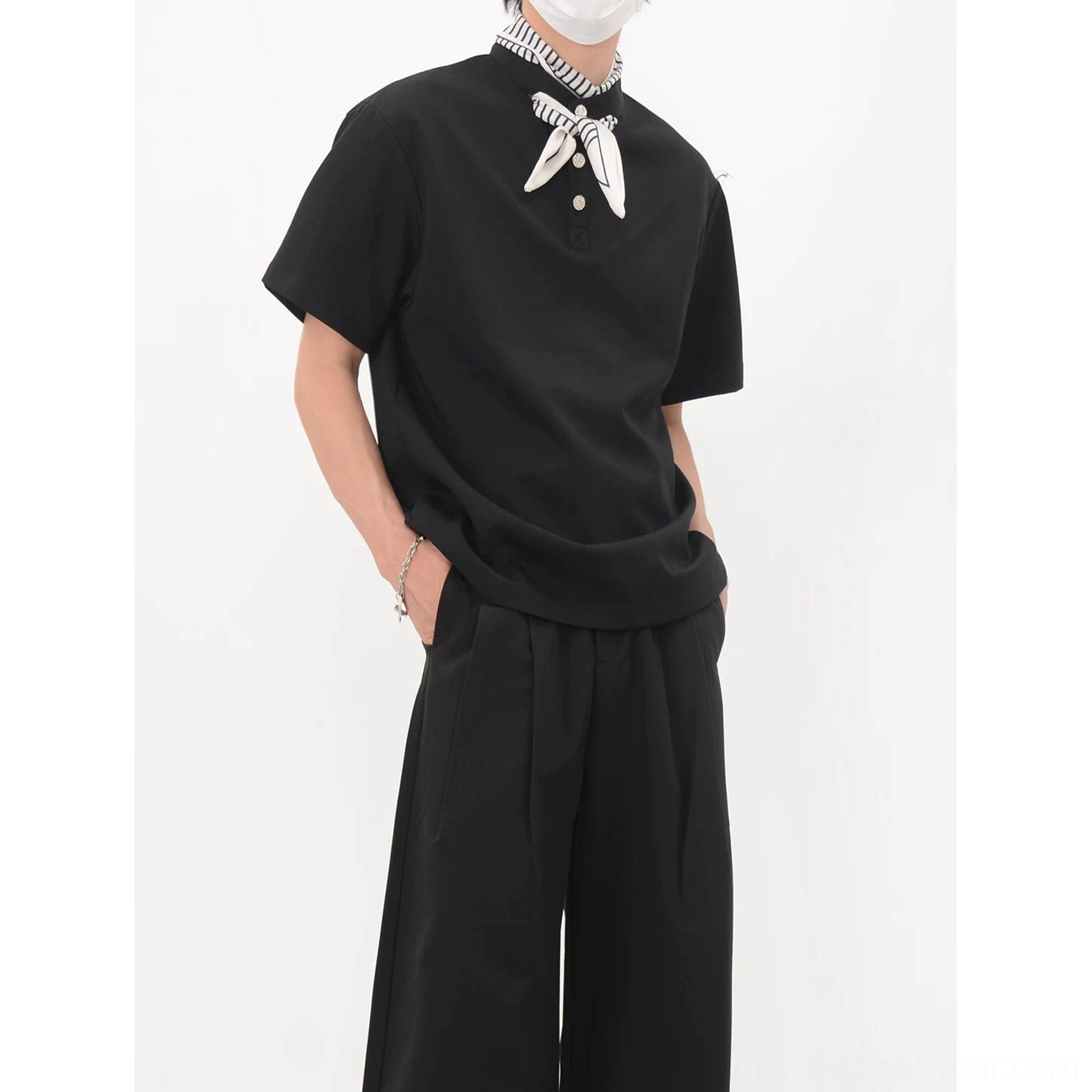 Black bandana collar polo tee product detail showing the three-button placket, stand collar and striped scarf accent
