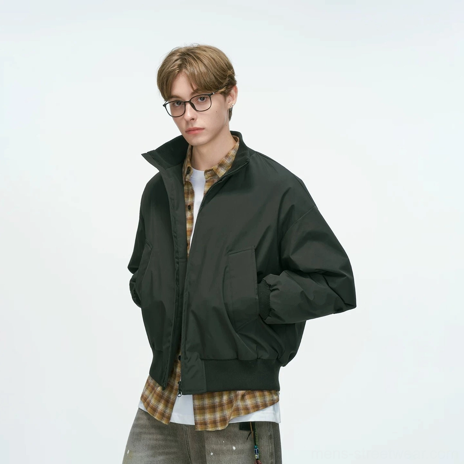 Black bomber jacket standalone display shot featuring front zip closure, patch pockets and ribbed cuffs, clean streetwear essential colorway