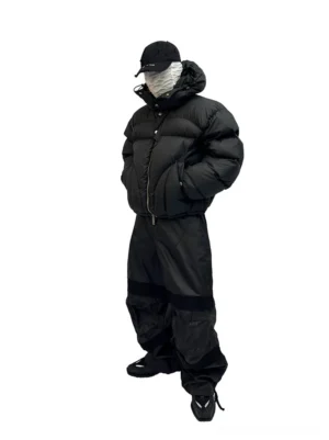Black boxy cropped puffer jacket three quarter front view with padded hood and snap storm placket