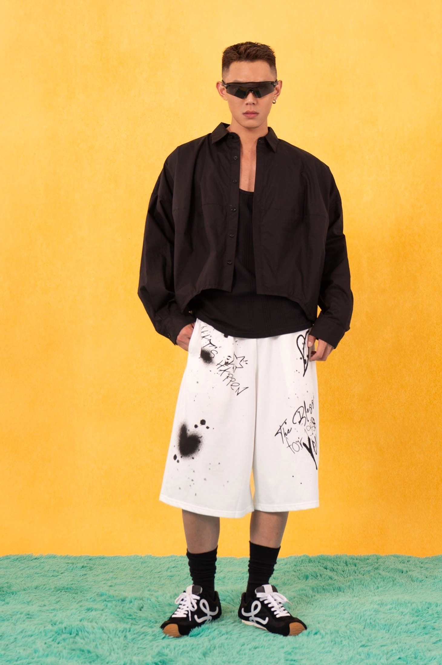 Black boxy oversized cropped poplin shirt worn with graphic white shorts in contemporary Korean streetwear fashion