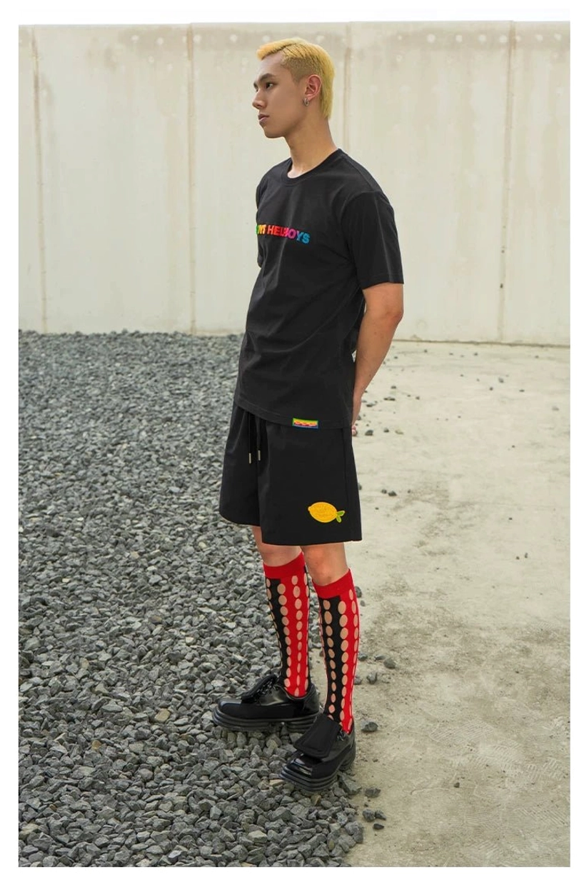 Black Boys Help Boys rainbow graphic streetwear T-shirt styled with black shorts and red cutout knee socks