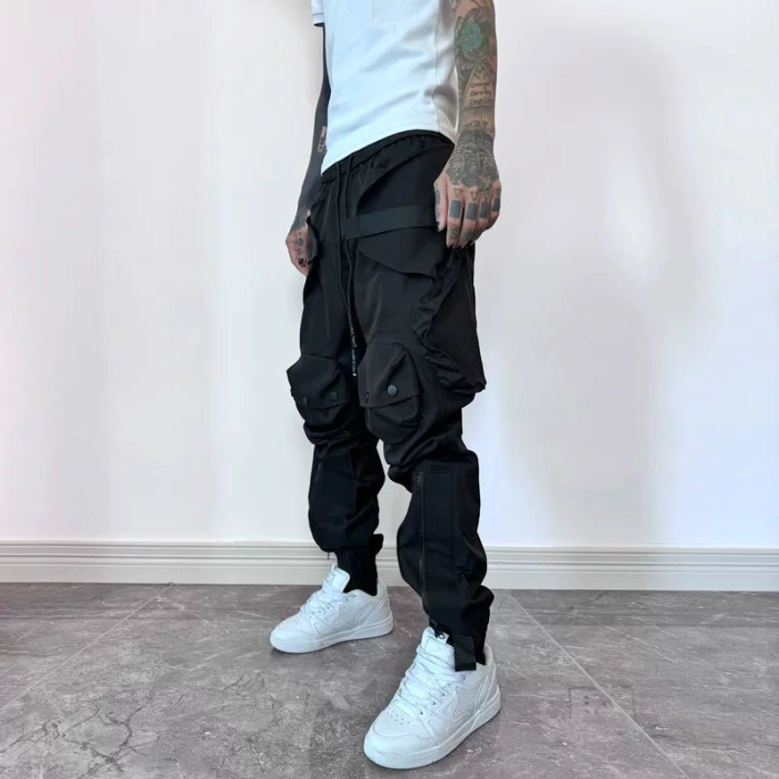 Black and brown tech cargo joggers styling detail with functional zippers, cargo compartments and adjustable cuffs