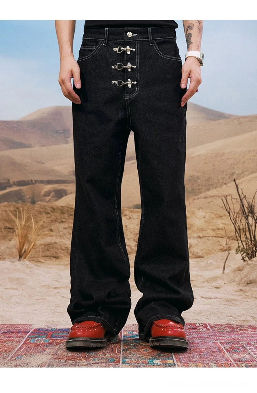 Full-body front view of black men's buckle embellished jeans with wide legs, silver hardware, and red leather shoes