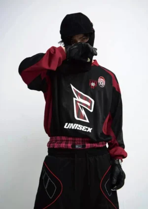 Front view of black and burgundy oversized racing team streetwear sweatshirt with chest emblem and shoulder badge details
