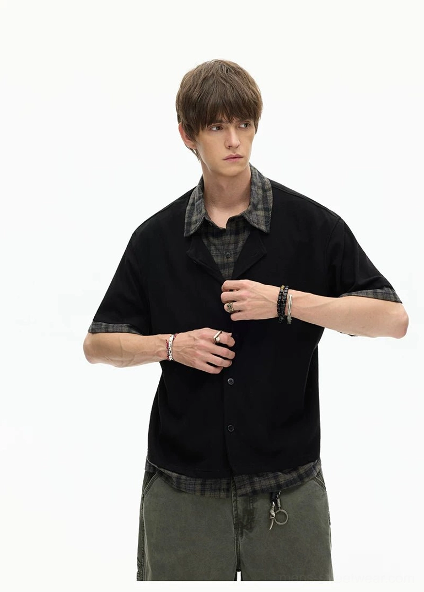 Black button-front layered plaid hem knit shirt close view showing Korean streetwear styling and trim