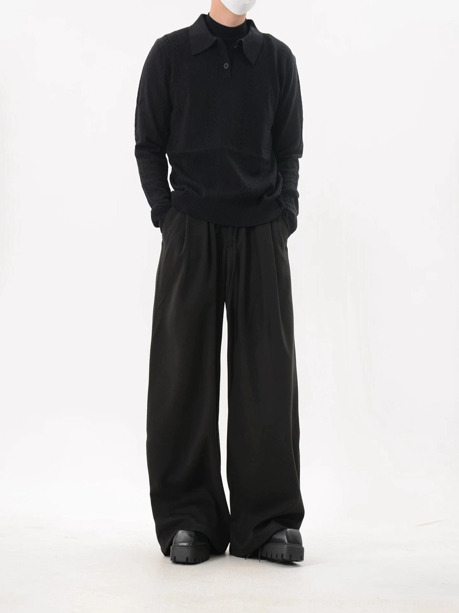 Black cable knit polo sweater styled with wide-leg pants and leather shoes for a refined Korean minimalist streetwear look