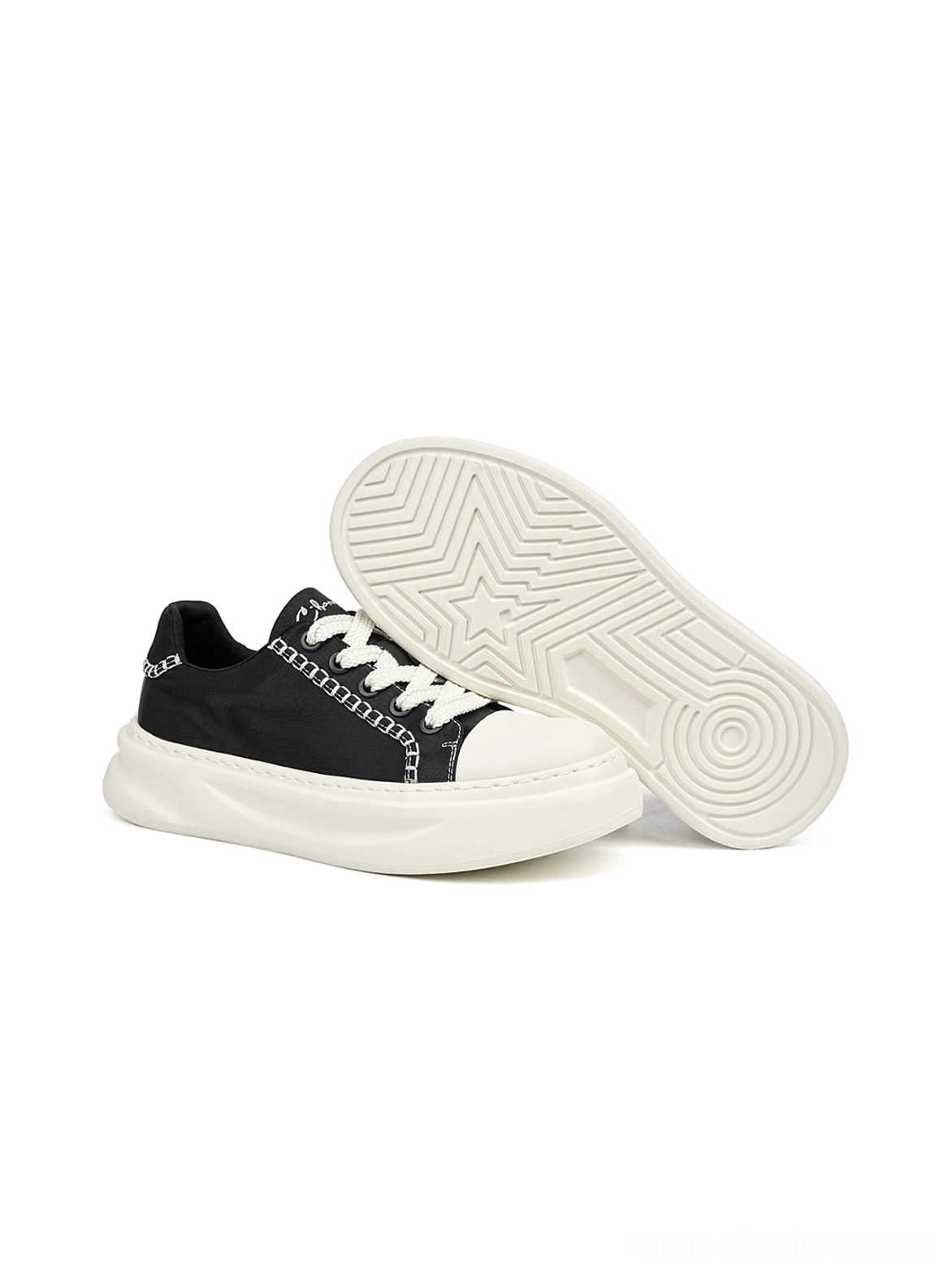 Black canvas platform sneakers with metal chain detail, white laces, and thick off-white sole for modern urban streetwear outfits