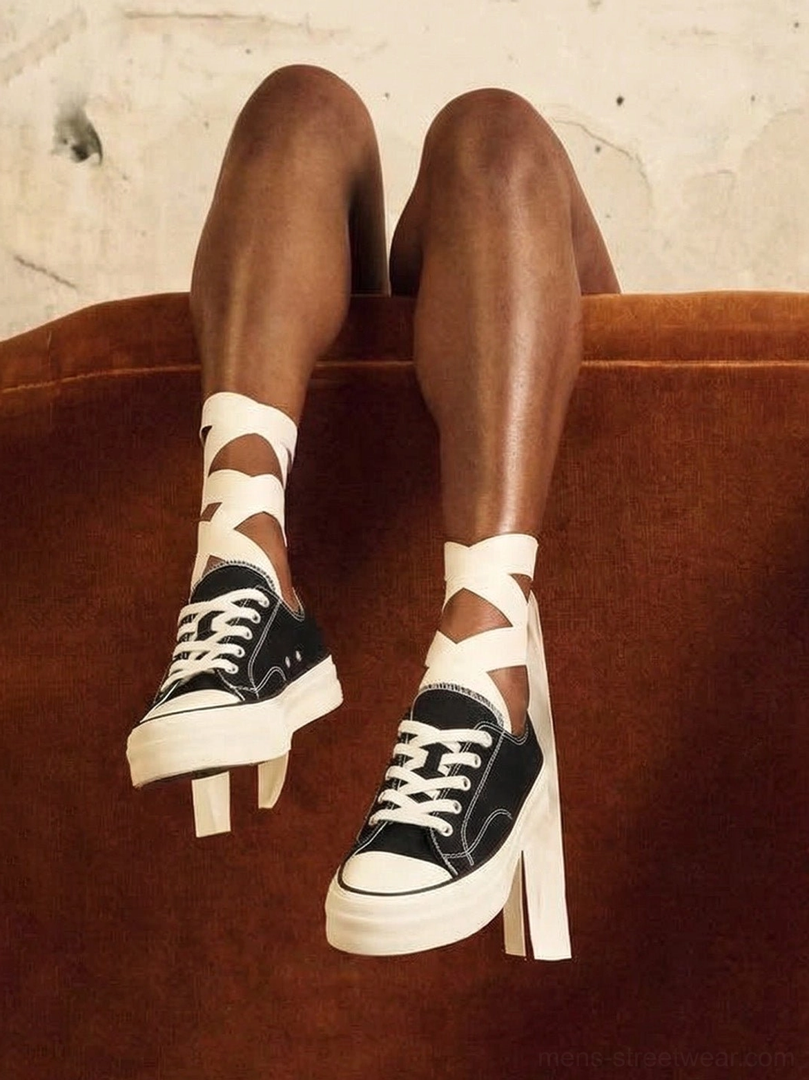 Black canvas platform sneakers worn with crisscross ribbon socks in a vintage streetwear lifestyle setting