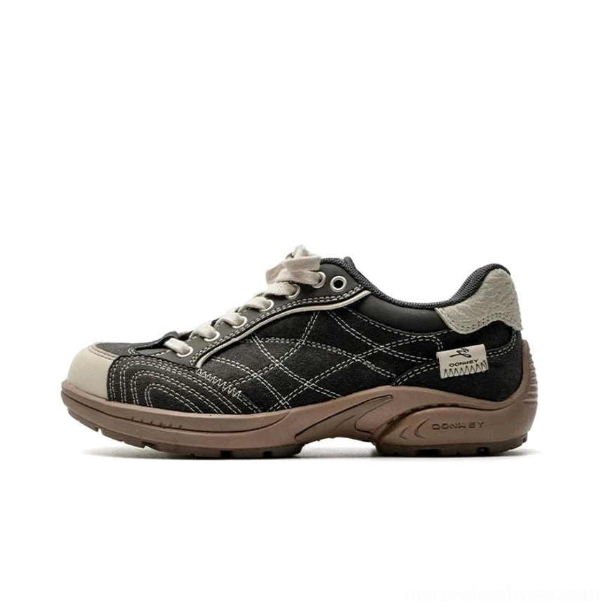 Black canvas retro runner sneakers with beige toe cap, detailed crisscross stitching, rounded toe, and brown rubber outsole