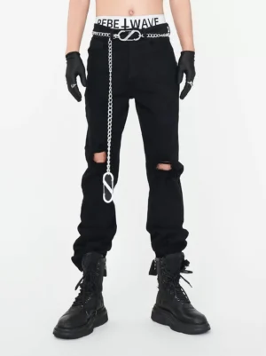 Front view of black chain detail ripped straight leg punk streetwear jeans styled with black gloves and platform combat boots