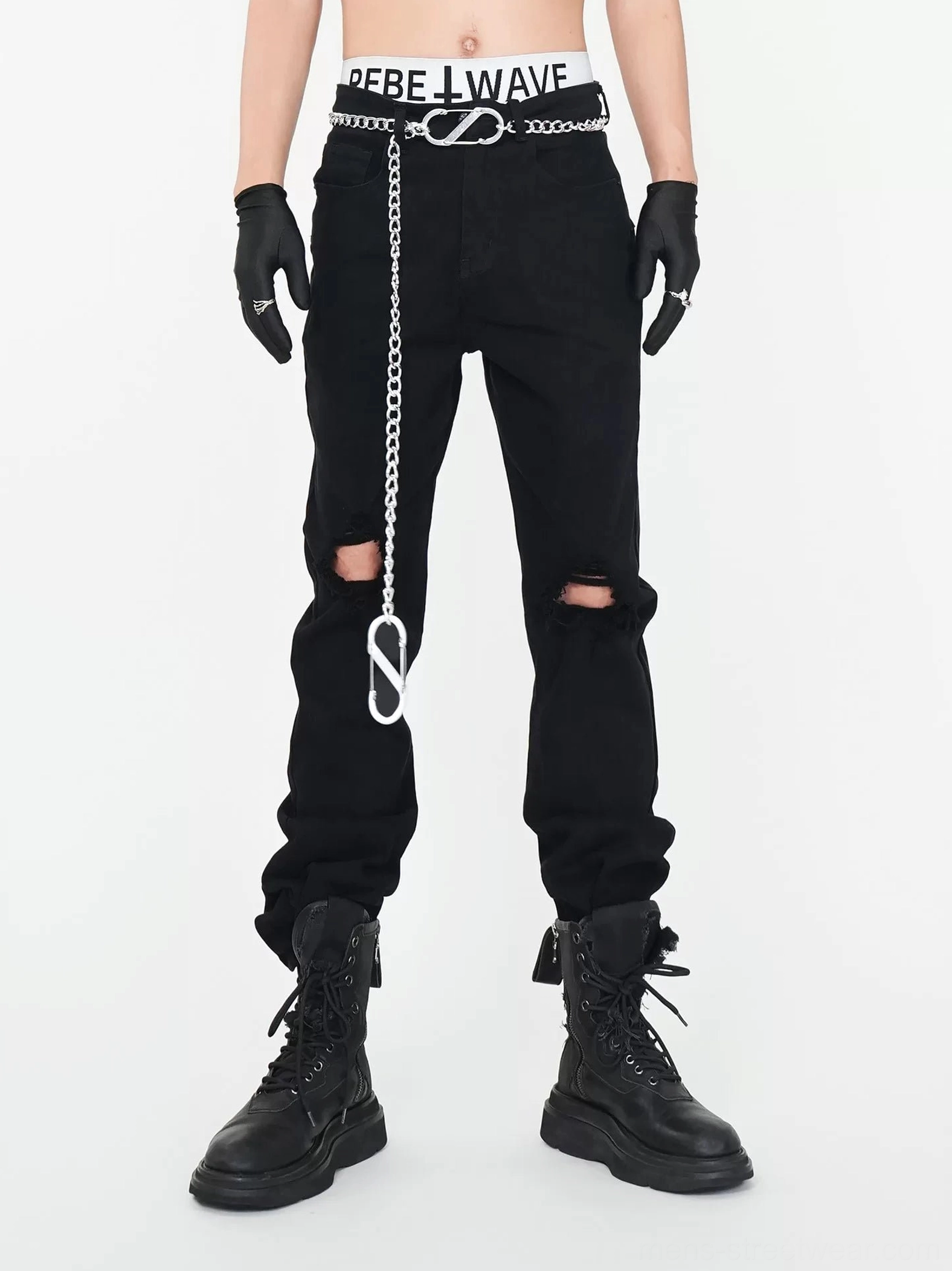 Front view of black chain detail ripped straight leg punk streetwear jeans styled with black gloves and platform combat boots