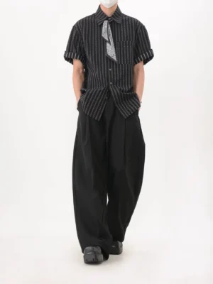 Back three-quarter view of black chainstripe men's streetwear shirt styled with wide-leg trousers and detachable neck scarf