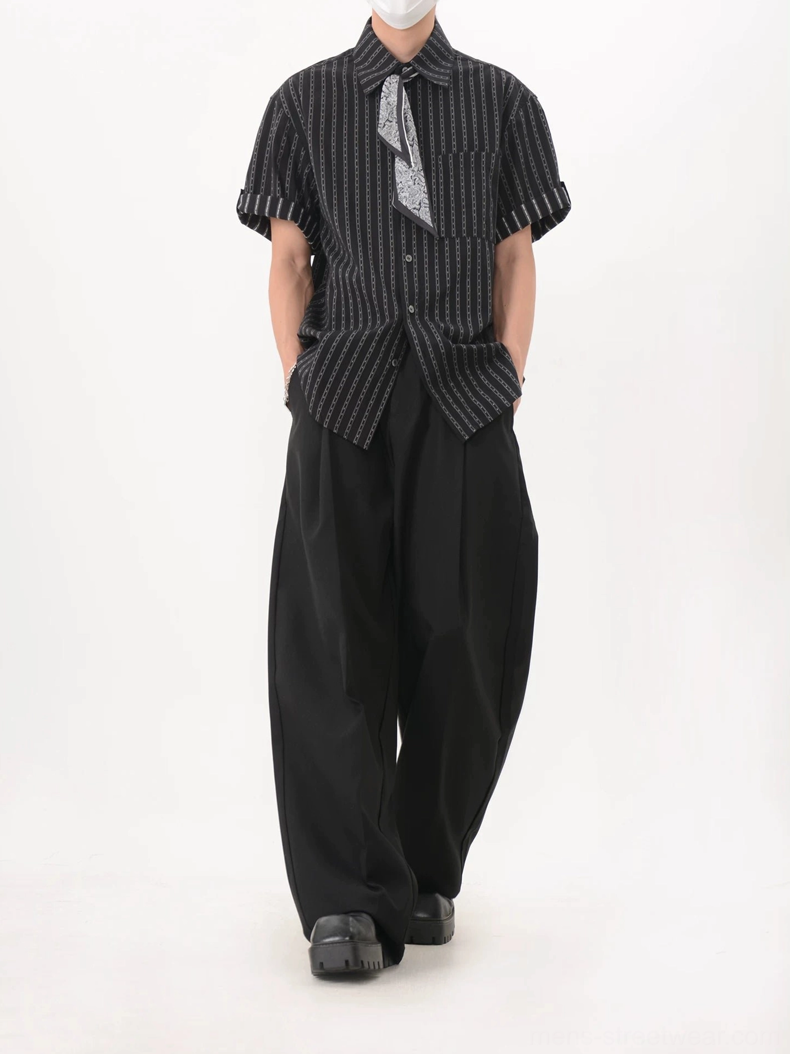 Back three-quarter view of black chainstripe men's streetwear shirt styled with wide-leg trousers and detachable neck scarf