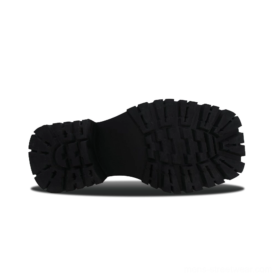 Overhead view of black chunky Derby shoe outsole with thick platform construction and deep multi-directional lug tread