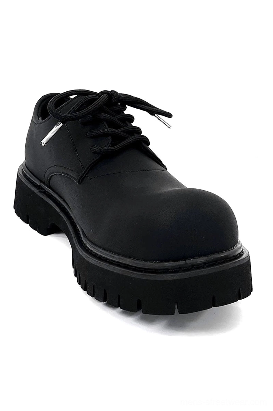 Black chunky platform derby shoe styling reference with rounded toe lace-up front and oversized lug sole