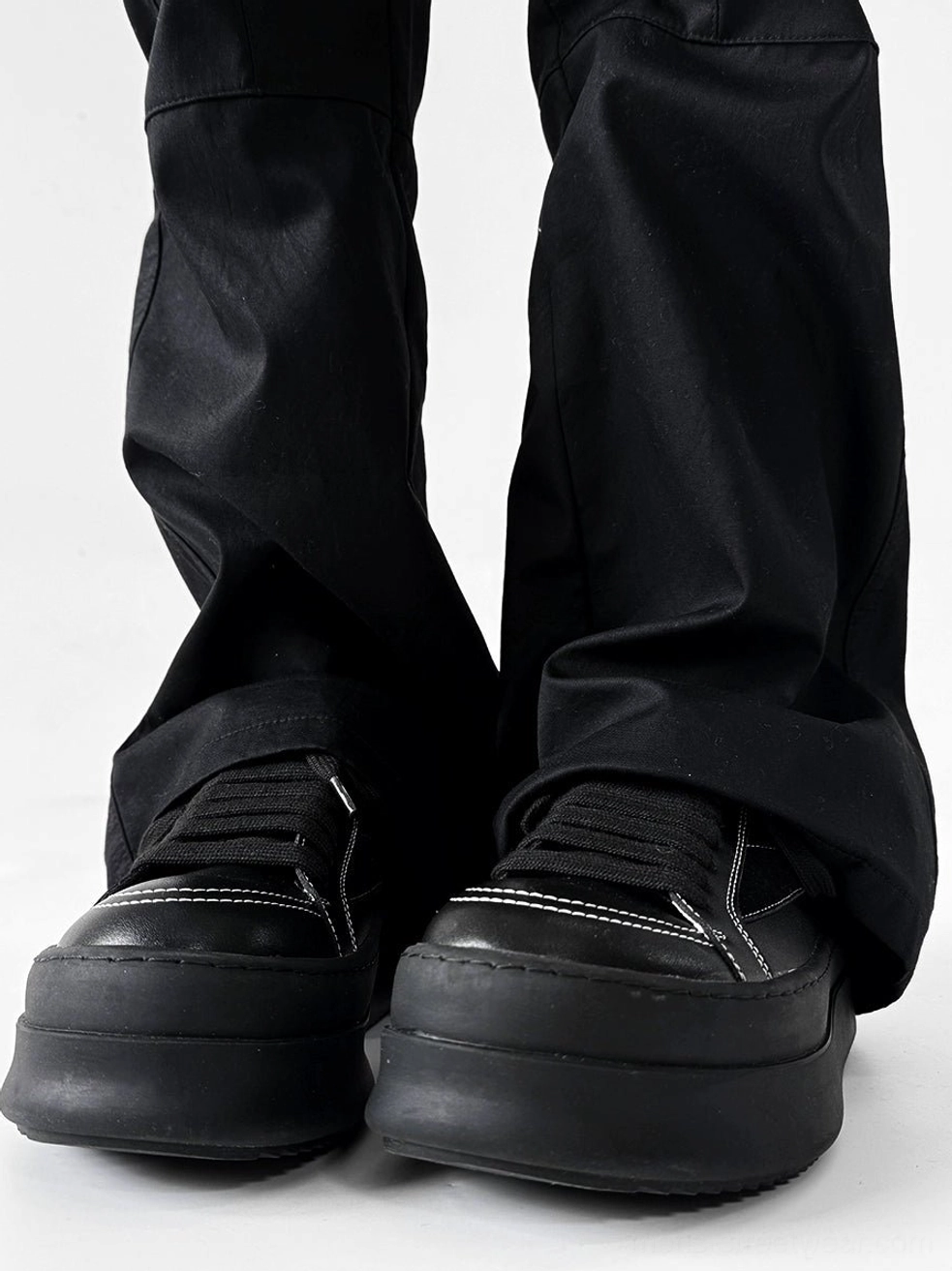 Black chunky platform sneakers with elevated sole and contrast detailing for everyday streetwear