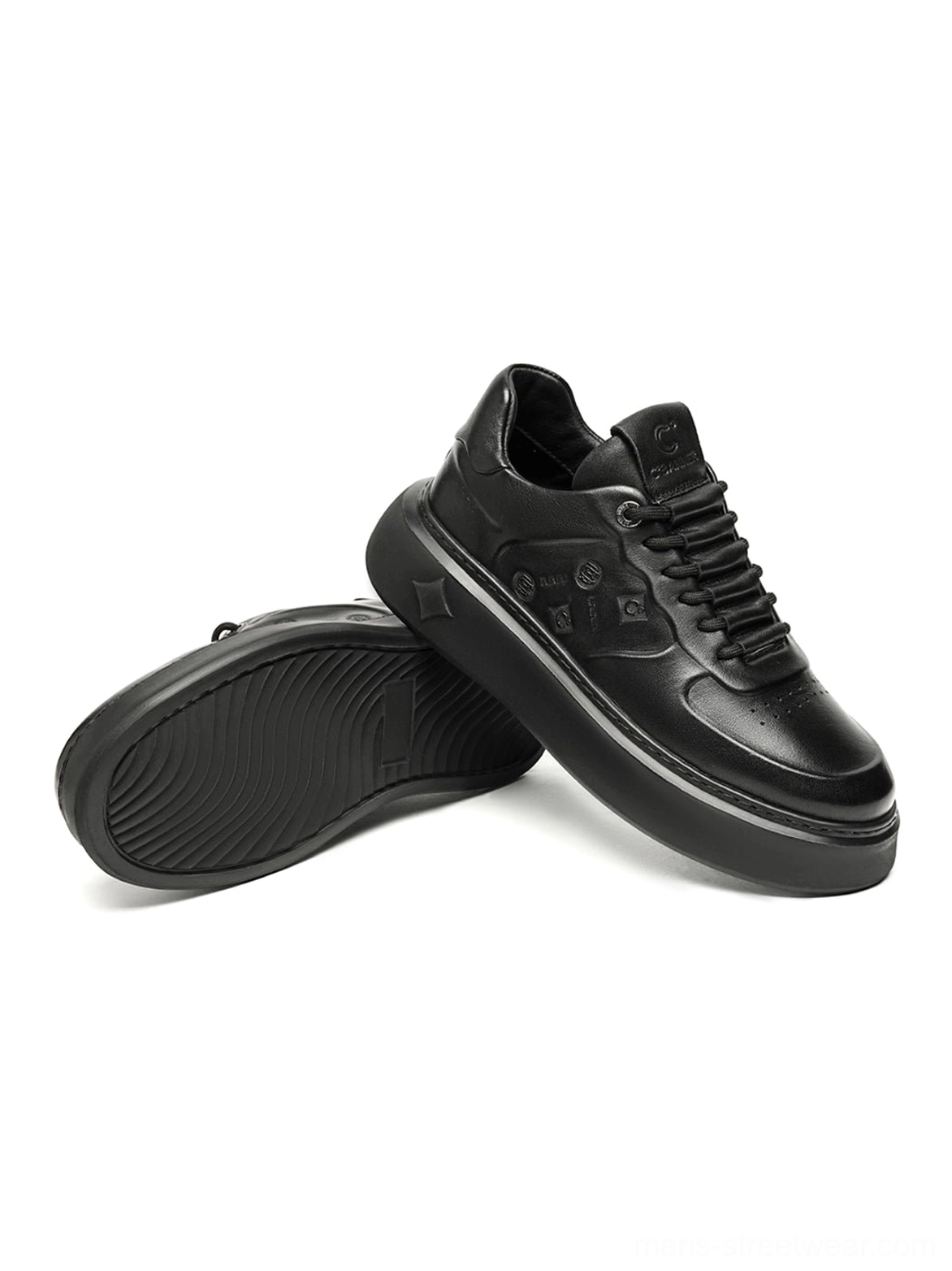 Black chunky platform sneakers with a structured low-top shape, embossed upper details, and versatile monochrome styling