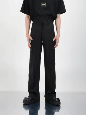 Black clean fit high-waisted straight-leg dress pants styled with black t-shirt and platform leather shoes front view