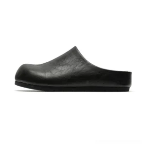 Black closed-toe backless leather-look mule clogs with rounded toe and low flat anti-slip sole shown in side profile