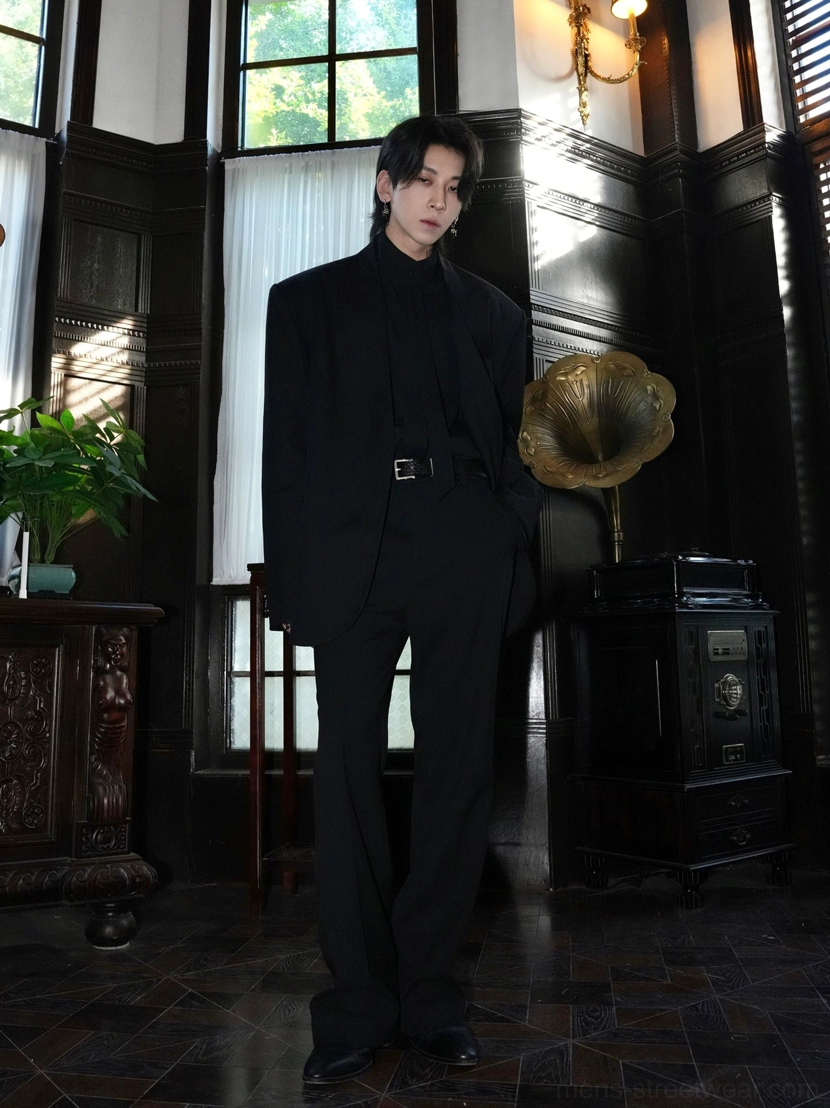 Black collarless oversized blazer styled with tailored trousers in a dark vintage interior for Seoul fashion inspiration