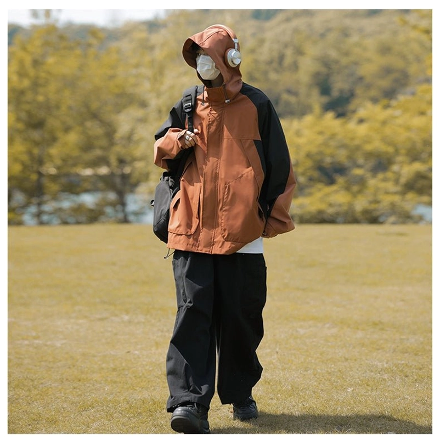 Black colorblock hooded outdoor jacket with utility pocket styling and relaxed techwear proportions