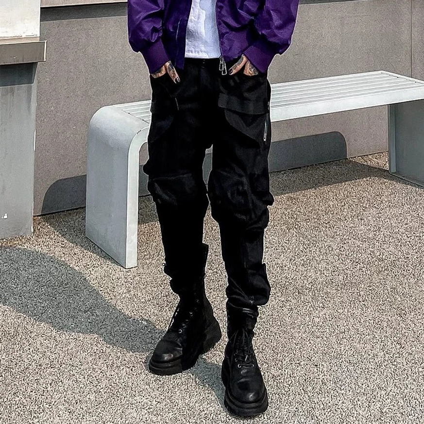 Black combat cargo jogger pants front detail with multiple side utility pockets, tapered elastic cuffs, and modern Korean streetwear styling