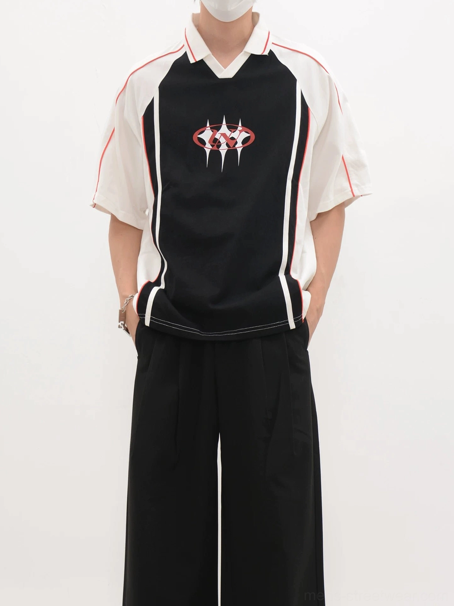 Black contrast panel soccer jersey shirt with white sleeves, white collar, vertical side stripes, and minimalist chest crest