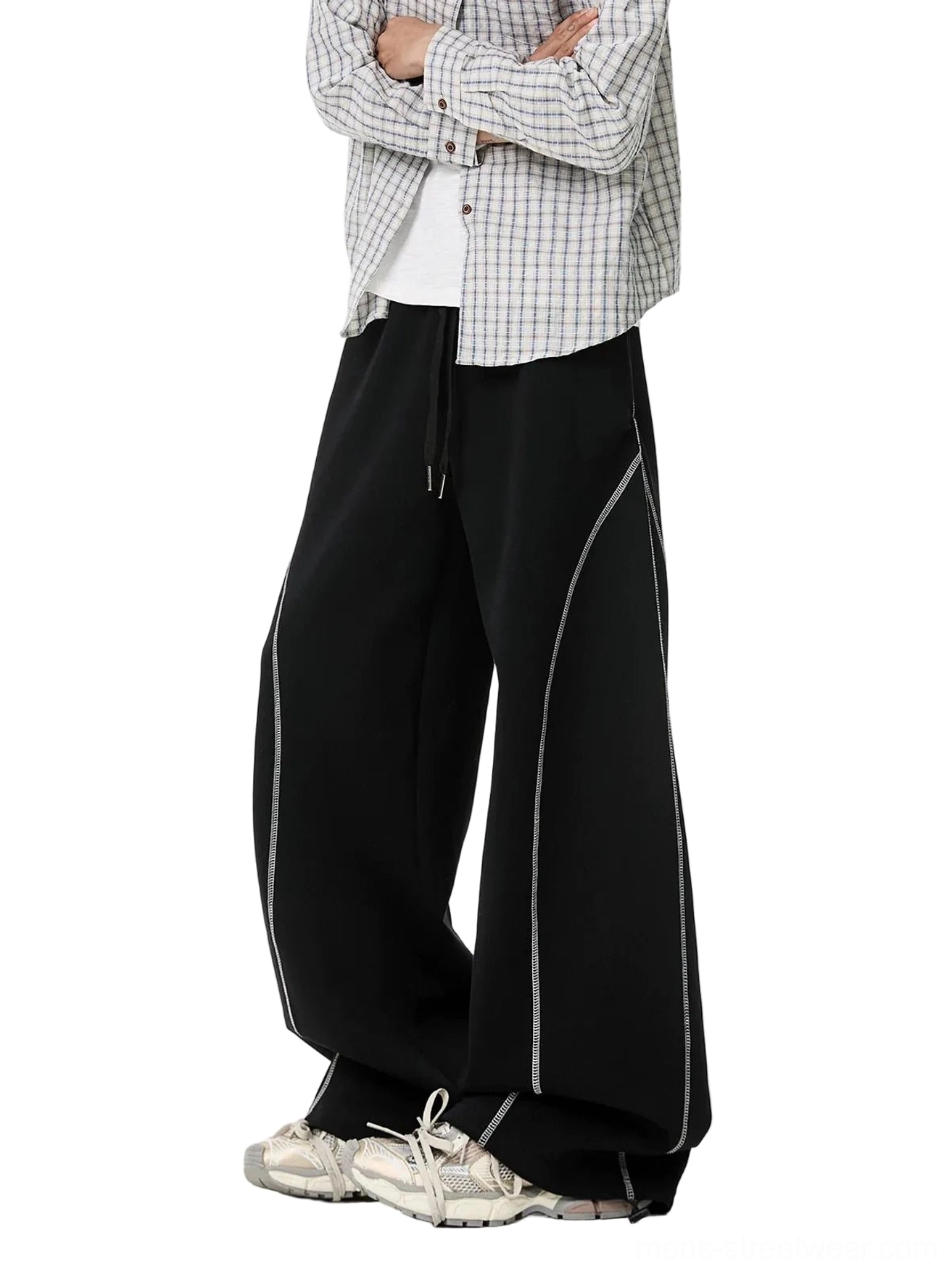 Black contrast stitch balloon sweatpants side studio view with baggy wide leg fit and stacked hem over sneakers