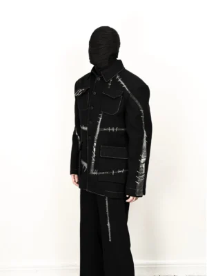 Side profile of black contrast stitch utility work jacket showing the relaxed fit, button front, utility pocket construction, and matching streetwear styling