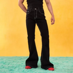 Men's black contrast stitching flared jeans with high waist and dramatic wide leg front three-quarter view