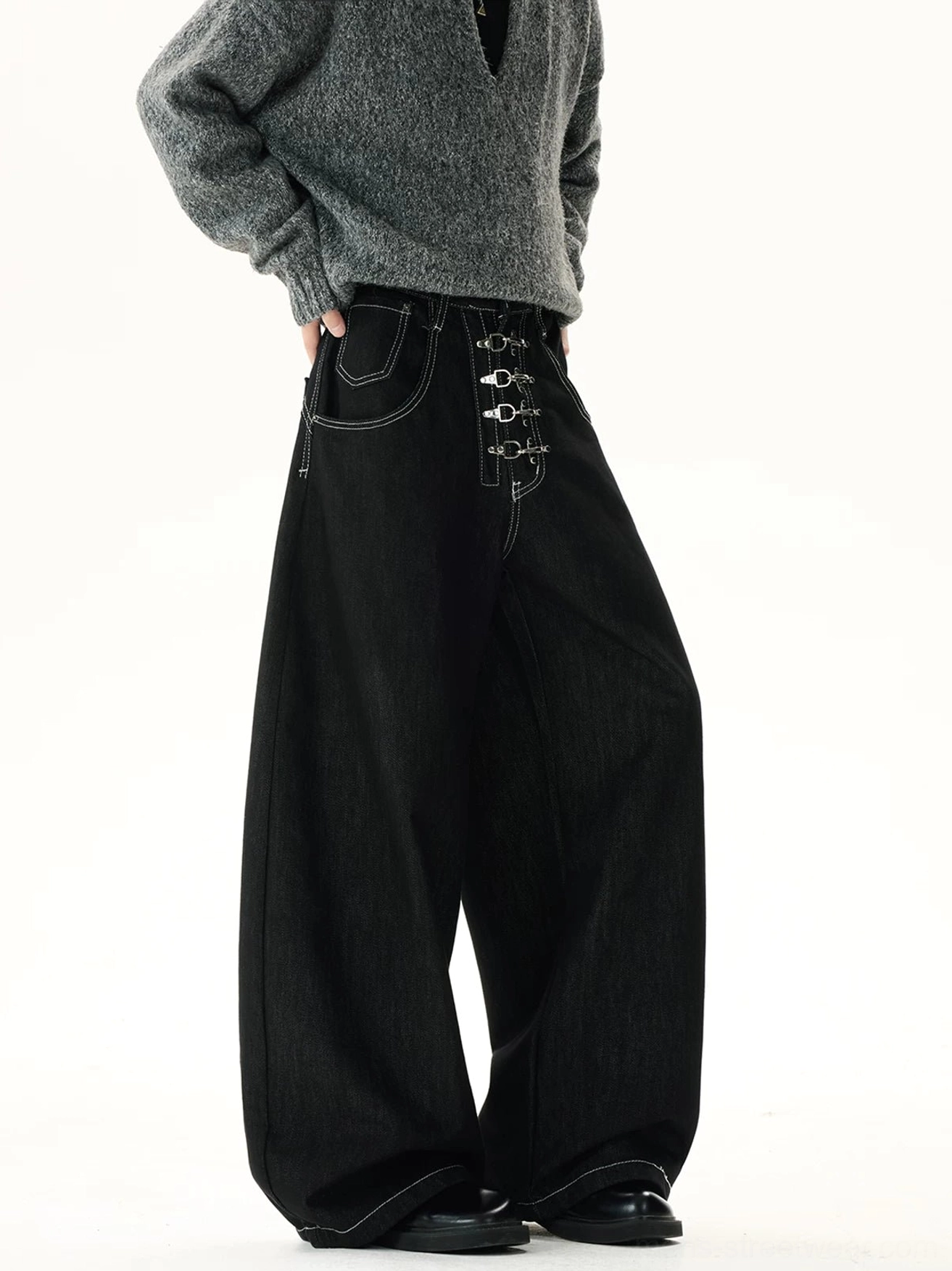 Side view of black corset-inspired wide-leg jeans with visible metal front fasteners, clean contrast stitching, relaxed fit, and contemporary Seoul streetwear design