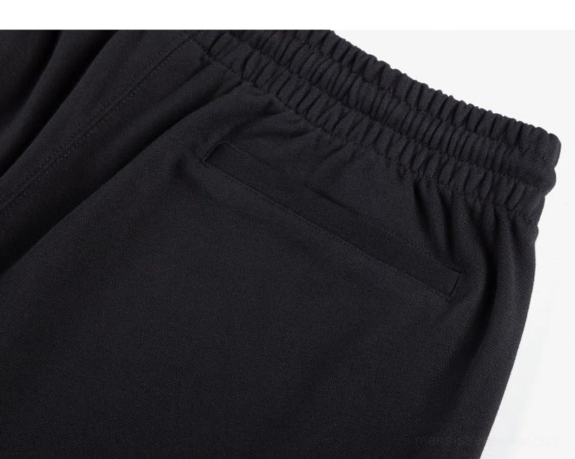 Detailed view of black cotton-blend sweat shorts elastic waistband side pocket and soft knit fabric texture