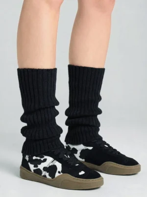 Black cow print horsehair low-top sneakers worn with black ribbed leg warmers rear view streetwear styling