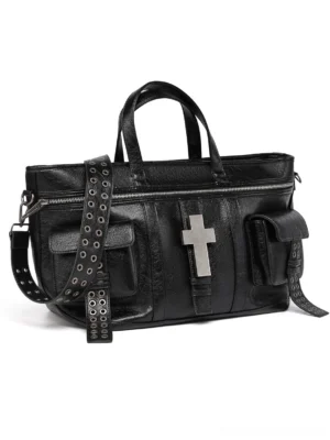 Black cracked leather crossbody tote bag with detachable grommet studded shoulder strap, silver cross ornament, top handles, and exterior utility pockets front view