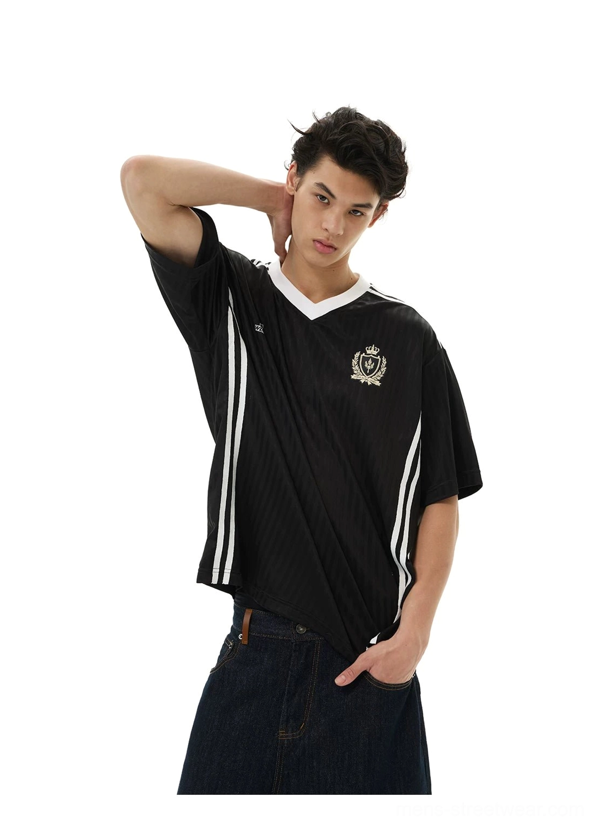 Black crested soccer jersey tee styled with dark denim, contrast V-neck, shoulder stripes, and number 17 chest detail