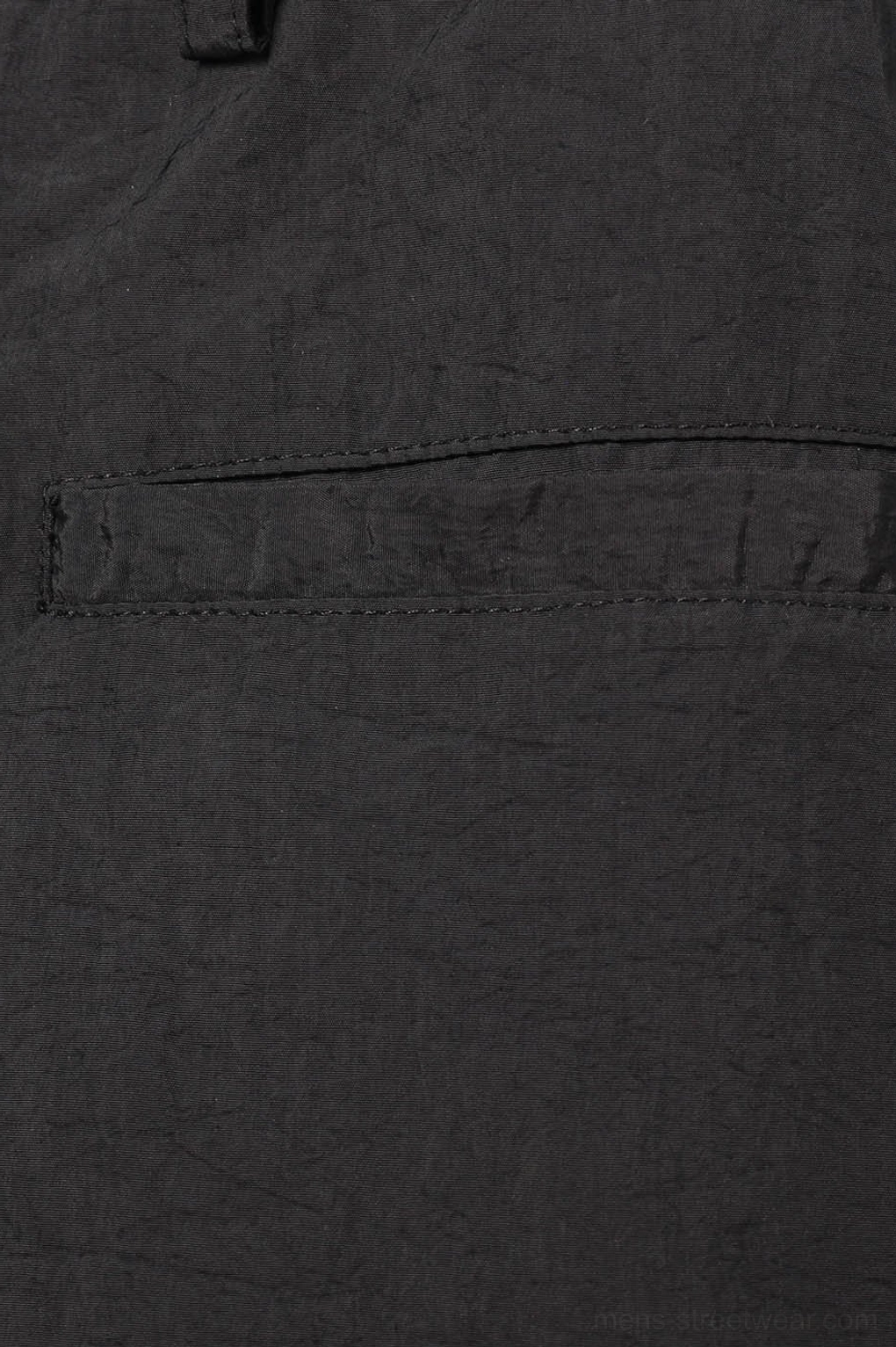 Black crinkled nylon wide-leg track pants detailed product view with adjustable drawstring hems