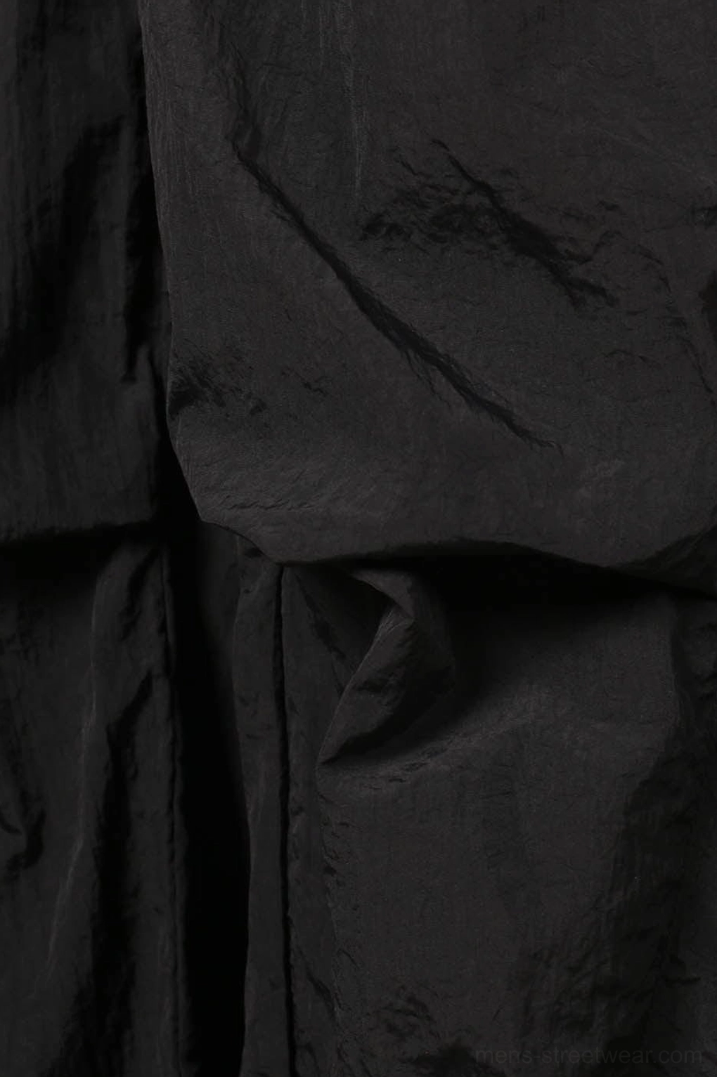 Black nylon wide-leg track pants technical streetwear product image showing relaxed loose fit