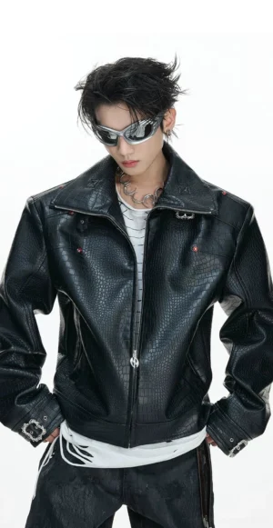 Close front view of black croc embossed faux leather cropped moto jacket with padded shoulders zipper and buckle cuffs