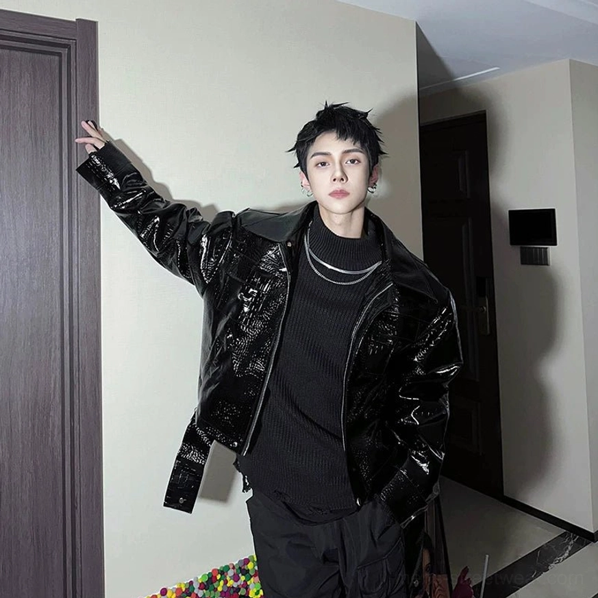 Black patent crocodile embossed moto jacket styled with layered silver necklaces and adjustable hem straps