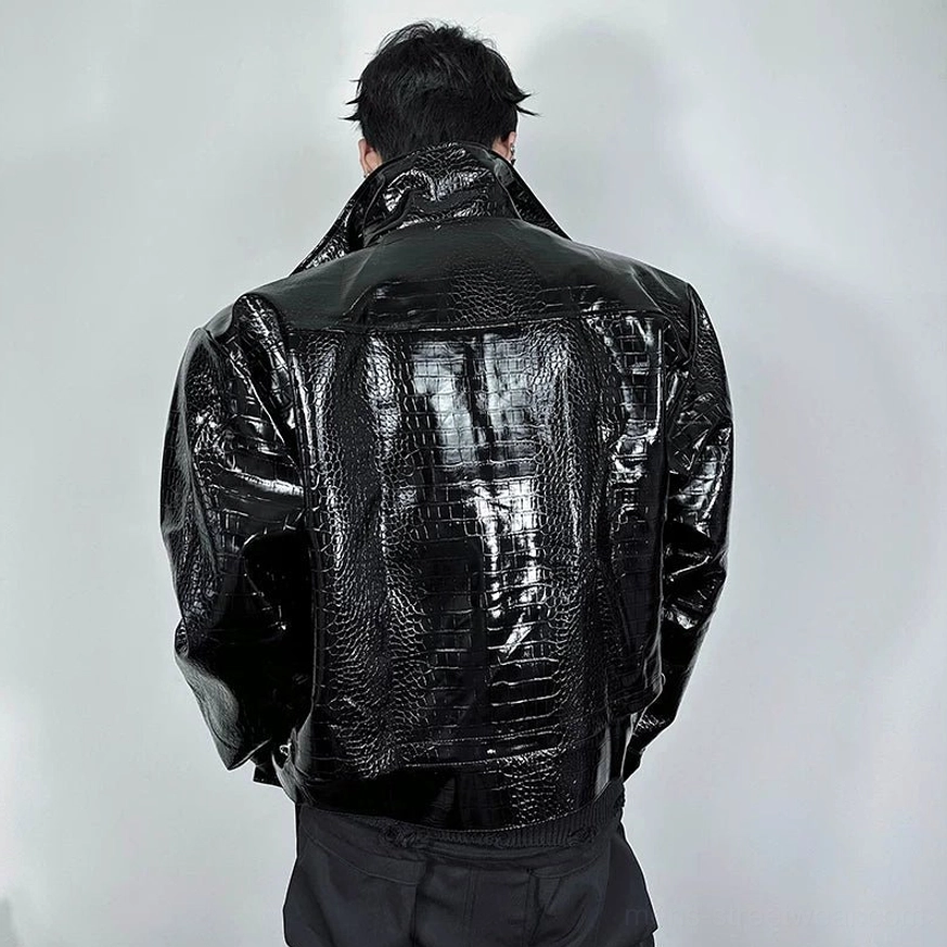 Back view of black crocodile embossed faux leather moto jacket with relaxed oversized silhouette and paneled seams