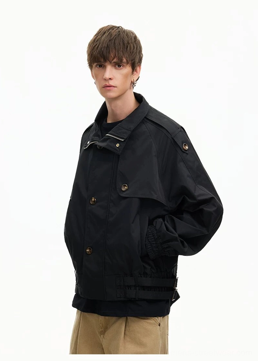 Side view of black cropped cinch-hem windbreaker jacket with stand collar smooth woven texture and relaxed streetwear fit