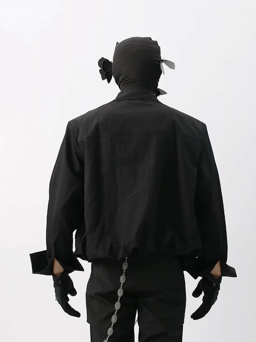 Rear view of black cropped cotton poplin shirt showing back yoke seam wide cuffs and relaxed streetwear silhouette