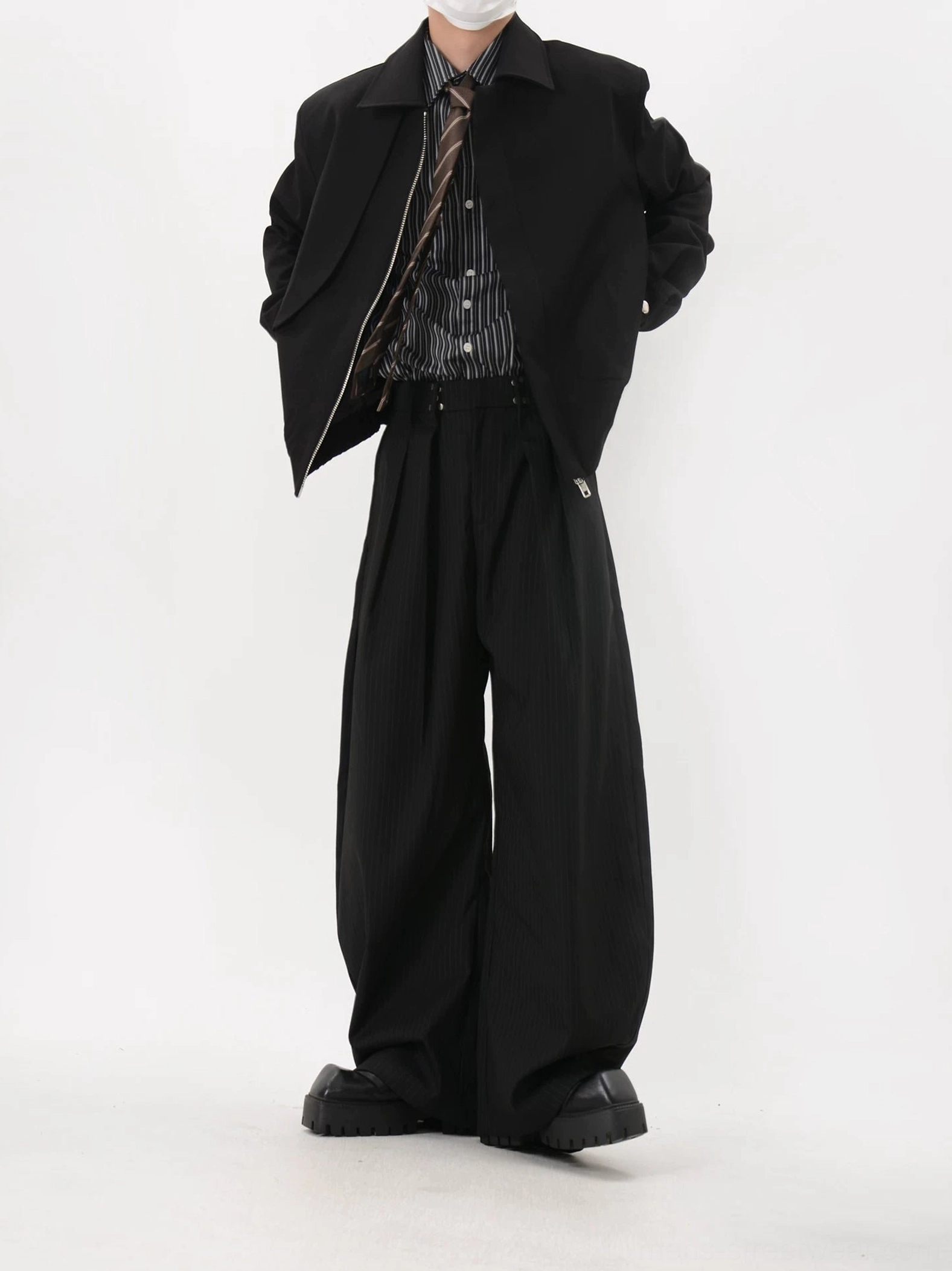Side view of black cropped elastic hem blouson jacket in Korean minimalist streetwear styling